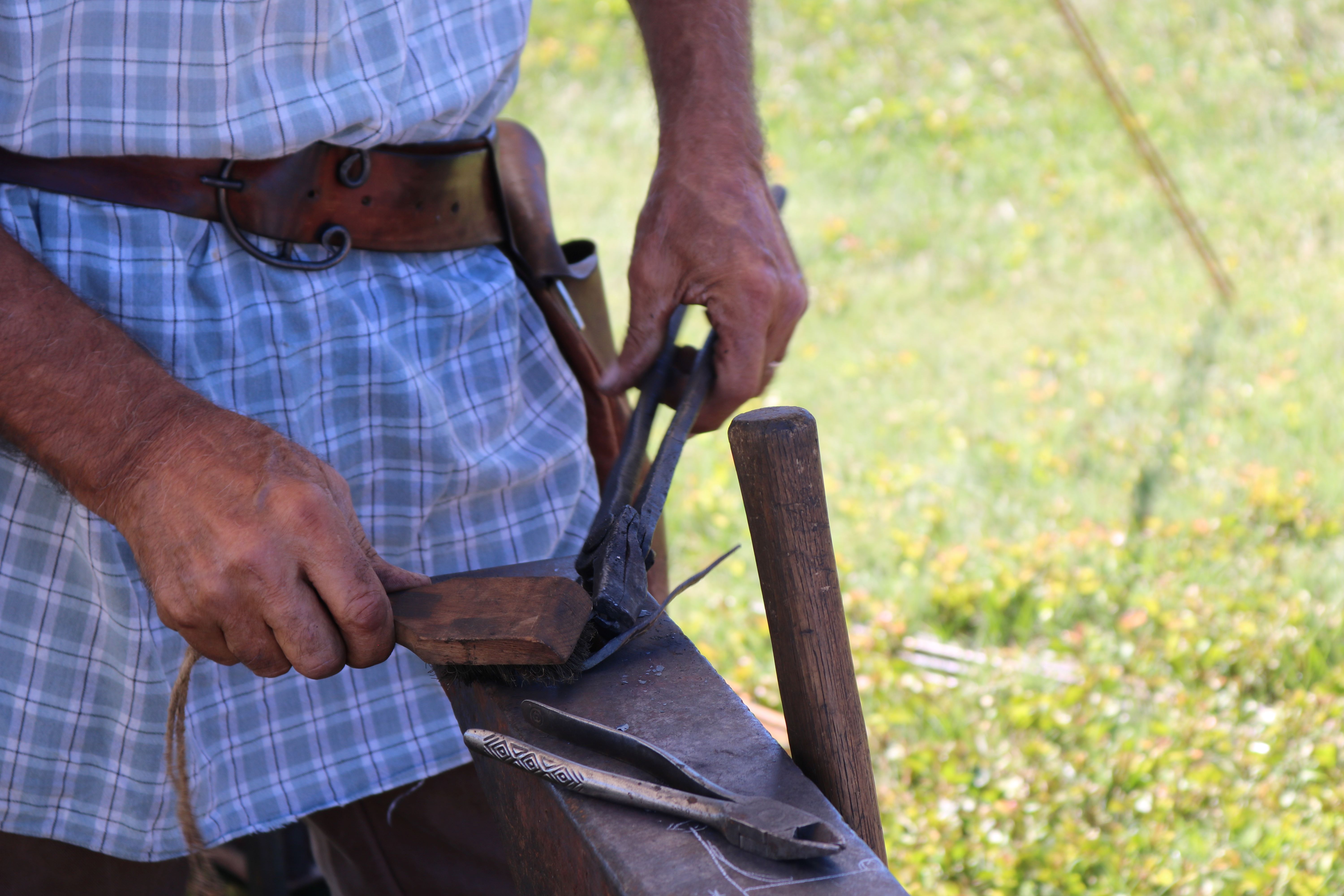 Blacksmith Station Image 6: close up of the blacksmith working on the metal.