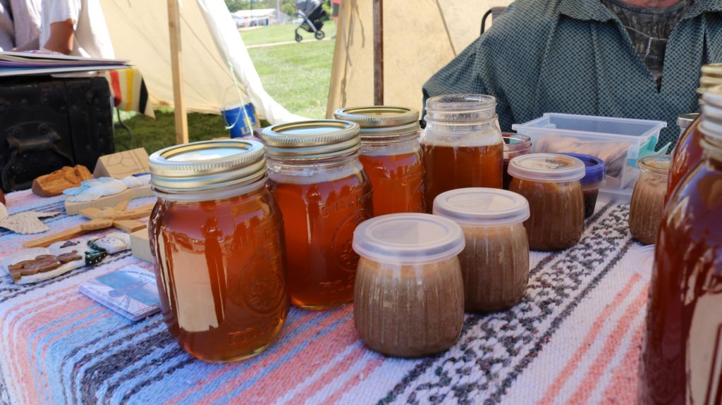 Woodcarving and Honey Exhibit Image 3: image showcasing the honey and some of the woodcarving pieces.